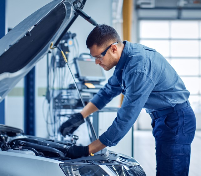 Car AC Repair Musaffah technician inspecting vehicle air conditioning system